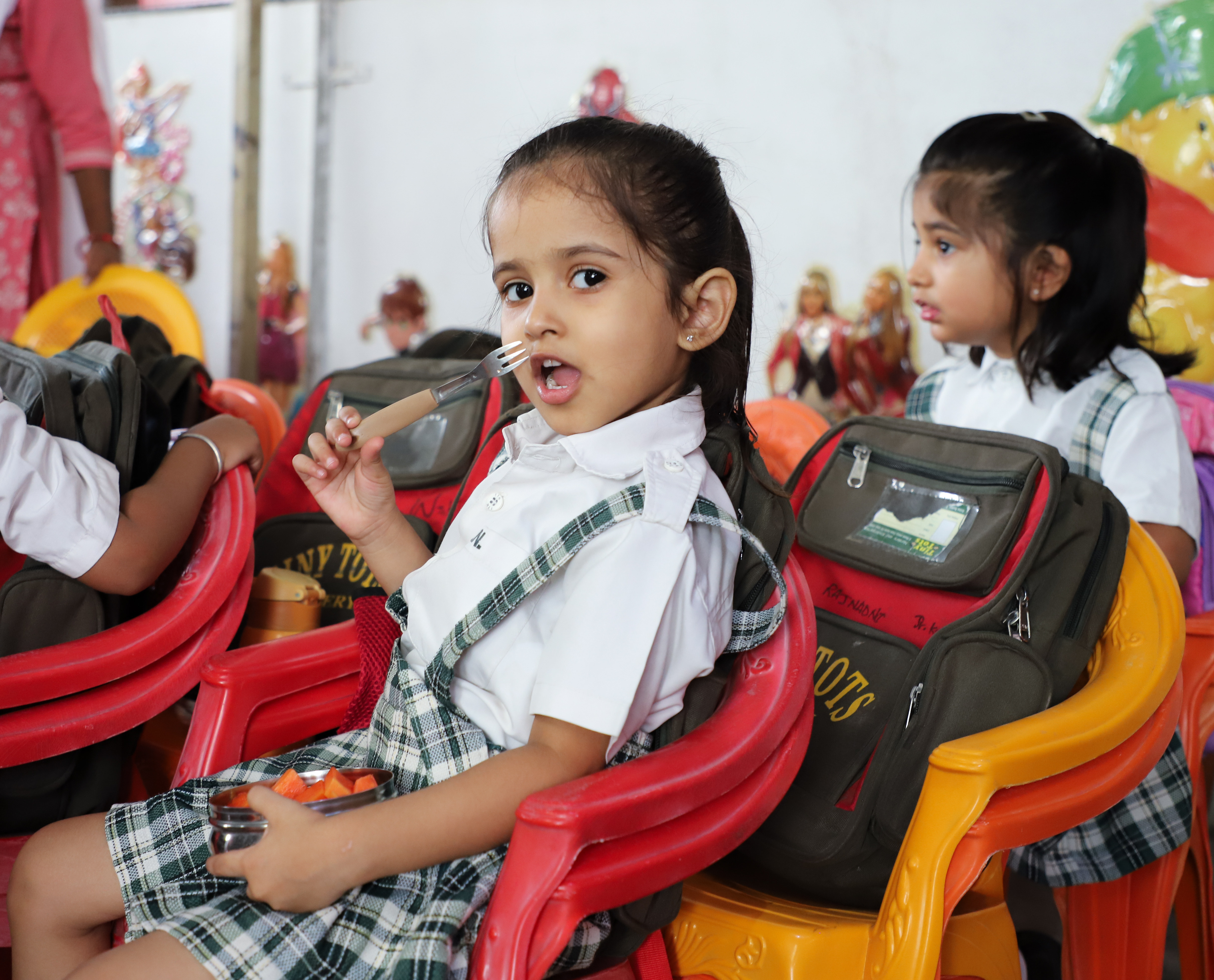 Teachers and children playing together in a kindergarten classroom